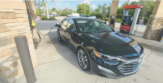  ?? HENRY PAYNE/DETROIT NEWS ?? A 2023 Chevy Malibu took on 328 miles’ worth of fuel in a minute, according to Henry Payne, who writes that he rented the Malibu instead of an EV during a vacation.
