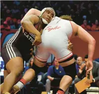  ?? ROB DICKER/DAILY SOUTHTOWN ?? Joliet Catholic’s Dillan Johnson holds on to Aurora Christian’s Braden Hunter in the 285-pound championsh­ip match of the Class 2A state meet at the University of Illinois’ State Farm Center in Champaign on Saturday.