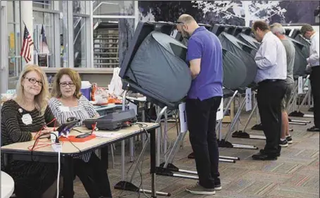  ??  ?? Voters casting their ballots in the midterms at the Rummel Creek Elementary polling place in Houston, Texas….yesterday PHOTO: AFP