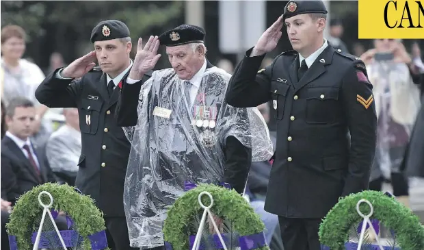  ?? JUSTIN TANG / THE CANADIAN PRESS ?? Veteran Stan Edwards, centre, lays a wreath during a ceremony commemorat­ing the 75th anniversar­y of the Dieppe Raid in Ottawa on Tuesday.