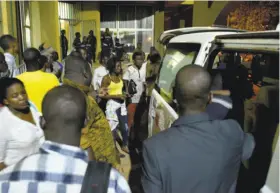  ?? Ahmed Ouoba / AFP / Getty Images ?? People evacuate the area where attackers opened fire on diners at a restaurant popular with foreigners in Ouagadougo­u, Burkina Faso, on Sunday night.