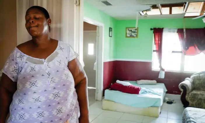  ?? Photograph: Angel Valentin/The Guardian ?? Erica Roberts, 41, a resident of the High Rock area of Freeport, stands inside her home which was destroyed by Hurricane Dorian.