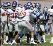  ?? JULIO CORTEZ — THE ASSOCIATED PRESS ?? New York Giants offensive tackle Bobby Hart, center, scuffles with defensive tackle Damon Harrison during a brawl between players after a play at NFL football training camp Thursday in East Rutherford, N.J.