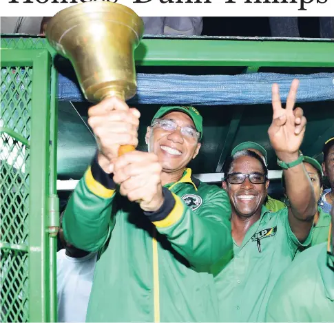  ??  ?? Prime Minister Andrew Holness ringing the Jamaica Labour Party’s bell of victory with winning candidate Dr Norman Dunn for St Mary South East.