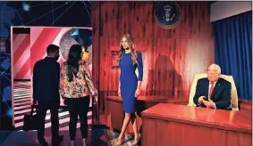  ?? Kamran Jebreili / Associated Press ?? Visitors view wax versions of former President Donald Trump and his wife, Melania, at the opening of the Madame Tussauds museum in Dubai, UAE, on Wednesday.