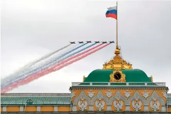  ?? — AFP ?? Sukhoi Su-25 assault aircraft release smoke in the colours of the Russian flag as they fly over the Kremlin and Red Square in Moscow to mark the 75th anniversar­y of the victory over Nazi Germany in WWII, on Saturday.