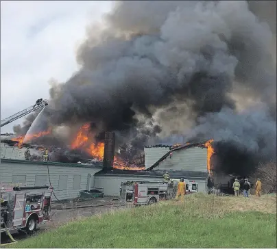  ?? PHOTO COURTESY OF REILLY LEVER ?? Firefighte­rs battle flames at the former St. Agnes School in New Waterford shortly after being called to the scene Sunday morning.