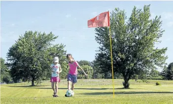  ?? JULIE JOCSAK/POSTMEDIA NEWS ?? Stacey Julie, 8, and sister Clara, 5, play a hole of footgolf at the Brock Golf Course in Thorold.