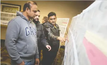  ?? DAX MELMER ?? Andy Patel, left, Ad Patel and Ashish Patel, owners of Kenore Motel, the Bestway Motel and the Royal Windsor Motel on Huron Church Road, discuss scheduled road work during a public informatio­n meeting.