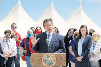  ?? JOE RAEDLE/GETTY ?? Gov. Ron DeSantis speaks to the media about the cruise industry during a news conference Thursday at PortMiami in Miami. The governor announced the state is suing the federal government to allow cruises to resume in Florida.