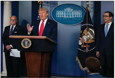  ?? (AP/Evan Vucci) ?? White House chief economic adviser Larry Kudlow (left) and Treasury Secretary Steven Mnuchin listen Thursday as President Donald Trump talks in Washington about the economy.