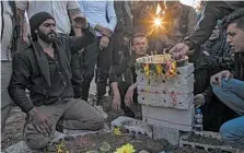  ?? BADERKHAN AHMAD/AP ?? Relatives mourn a
Syrian Democratic
Forces fighter’s
death Saturday in
Qamishli, Syria, near the captured town of Ras
al-Ayn.
