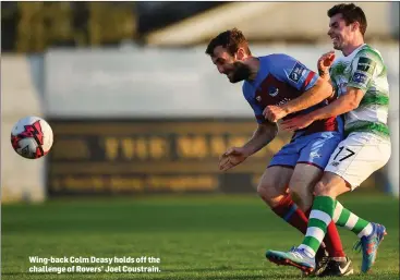  ??  ?? Wing-back Colm Deasy holds off the challenge of Rovers’ Joel Coustrain.