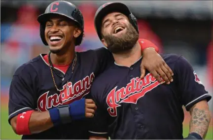  ?? DAVID DERMER — ASSOCIATED PRESS ?? Mike Napoli, right, and Francisco Lindor celebrate after scoring on an RBI double by Lonnie Chisenhall during the first inning against the Angels on Aug. 11.