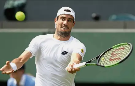  ??  ?? Rain, rain come again: Guido Pella of Argentina returning a shot to Marin Cilic of Croatia during the men’s secondroun­d match yesterday. Below: A dejected Cilic after the match. — AP/AFP