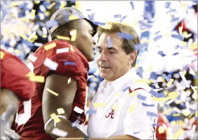  ?? Kevin C. Cox / Getty Images /TNS ?? Head coach Nick Saban of the Alabama Crimsontid­e celebrates with his players after their 32-13 win against the Florida Gators during the SEC Championsh­ip game at the Georgia Dome on Dec. 5, 2009, in Atlanta, Georgia.