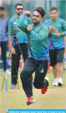  ??  ?? BANGALORE: Afghanista­n bowler Rashid Khan (C) bowls in the nets during the team’s practice session at the M. Chinnaswam­y Stadium in Bangalore yesterday. —AFP