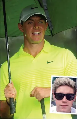  ?? GETTY IMAGES ?? Gimme shelter: McIlroy takes cover from the Augusta rain before he joins One Direction’s Niall Horan (inset) for today’s event