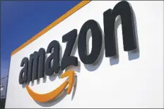  ?? MICHEL SPINGLER/AP ?? A COMPANY LOGO is seen at the entrance of Amazon, in Douai, northern France, on April 16, 2020.