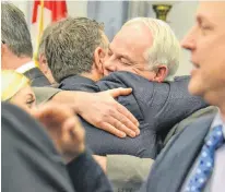  ?? STU NEATBY/THE GUARDIAN ?? Premier Dennis King and Opposition Leader Peter Bevan-Baker share a hug following the closure of the fall session at the P.E.I. legislatur­e on Thursday. The government passed more than 20 bills.