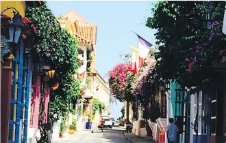  ??  ?? Cartagena’s chock-full of brightly coloured colonial buildings, cobbleston­e streets and beautiful bougainvil­lea.