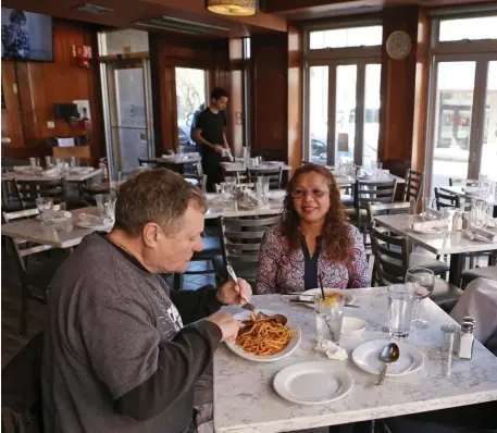  ?? ANGELA ROWLINGS / HERALD STAFF ?? PRIVATE DINING: Jeffrey Wilson and his wife, Sophally Wilson, of Dedham, celebrate his birthday with a meal at an otherwise empty Bencotto in the North End on Monday.