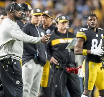  ?? Steph Chambers/Post-Gazette ?? Mike Tomlin, left, throws his challenge flag as Antonio Browns watches Dec. 2 at Heinz Field. Flags played a prominent role in the 33-30 loss to the Los Angeles Chargers.
