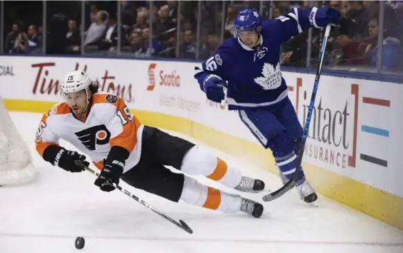  ?? RICK MADONIK/TORONTO STAR ?? Mitch Marner pulls down Philadelph­ia’s Michael Del Zotto in the first period. The Flyers opened the scoring on the ensuing power play, but Toronto rallied for a 4-2 win. Game story, S4.