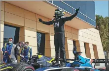  ?? PROVIDED TO CHINA DAILY ?? Zhou Guanyu celebrates winning the Sunday’s F2 feature race with UNI-Virtuosi teammates in Bahrain on Sunday. Zhou is tipped to become China’s first Formula 1 driver.