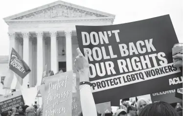  ?? SAUL LOEB Getty Images ?? LGBTQ rights advocates rallied outside the U.S. Supreme Court as the court heard oral arguments in three cases dealing with workplace discrimina­tion based on sexual orientatio­n.