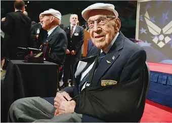  ?? AP Photo/Gary Landers, File ?? ■ Two members of the Doolittle Tokyo Raiders, retired U.S. Air Force Lt. Col. Richard “Dick” Cole, seated front, and retired Staff Sgt. David Thatcher, seated left, pose for photos April 18, 2015, after the presentati­on of a Congressio­nal Gold Medal honoring the Doolittle Tokyo Raiders at the National Museum of the U.S. Air Force at Wright-Patterson Air Force Base in Dayton, Ohio.