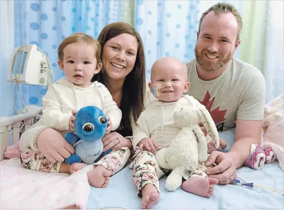  ?? CATHIE COWARD THE HAMILTON SPECTATOR ?? Brennah and Josh Lawlor and their 16-month-old twin daughters, Sophia and Addison. Addison has Acute Myeloid Leukemia. Her uncle, Lee Van Katwyk, is writing about her fight.