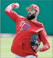  ??  ?? John Raoux / AP
Philadelph­ia Phillies pitcher Jake Arrieta throws during a workout Tuesday before an exhibition game against the Tampa Bay Rays.