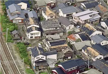  ?? REUTERS PIC ?? An aerial view showing damaged roof tiles of residentia­l houses caused by an earthquake in Tsuruoka, Yamagata prefecture, Japan, yesterday.