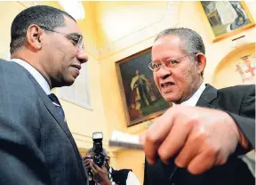  ??  ?? Prime Minister Andrew Holness (left) and former Prime Minister Bruce Golding converse at an event at King’s House in Kingston on December 7, 2016.