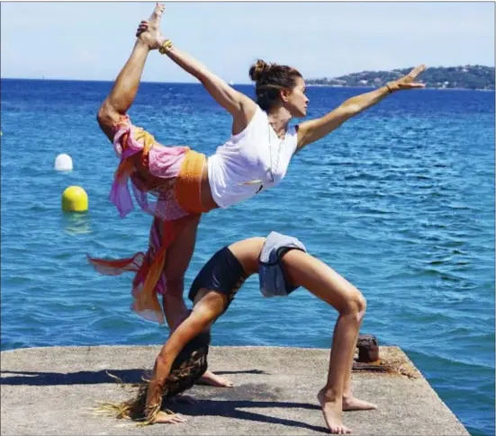  ?? BROOKE BURKE CHARVET VIA AP ?? This undated photo provided by Brooke Burke Charvet shows Charvet doing yoga with her daughter Rain in Malibu.