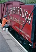  ?? ?? Norman Pannell lettering the Peterborou­gh Coal and Coke Co. Ltd wagon in the bay platform at Peterborou­gh Nene Valley Station as leader of the original wagon group.