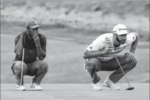  ?? AP PHOTO ?? Tiger Woods, left, and Dustin Johnson line up their putts on the 16th green during the first round of the U.S. Open Golf Championsh­ip, Thursday, in Southampto­n, N.Y.