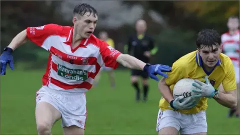  ??  ?? Diarmuid Kehoe of Geraldine O’Hanrahans tries to break away from Mark Doyle (St. Mary’s, Maudlintow­n) in their Greenstar Under-20 football Division 4 championsh­ip semi-final in The Rocks on Saturday.