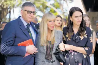  ??  ?? Michael Macklin, widow Yvonne Moore and Jacinda Ardern at the service yesterday.