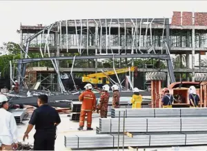  ??  ?? Collapse:Fire and Rescue Department officials checking the site of the accident in Prai.