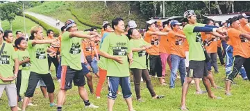  ??  ?? KTSP staff warming up during aerobics session.