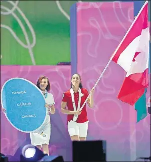  ?? CP PHOTO ?? Canadian women’s basketball player Kia Nurse acts as the flag-bearer during the closing ceremony of the 2015 Pan Am Games in Toronto on Sunday.