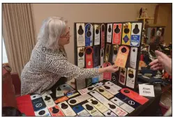  ?? File Photo/BEN GOFF ?? Alison Alison of Fayettevil­le talks to guests about her collection of ‘Do not disturb’ signs from hotels she has visited during the 2017 Cabin Fever Reliever open house at the Shiloh Museum of Ozark History in Springdale. The 2018 event is set for Jan....