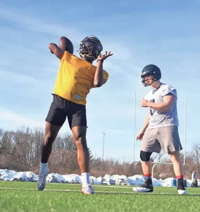  ?? CURT HOGG / NOW NEWS GROUP ?? Whitnall quarterbac­k Caleb Straughter warms up before practice on Monday.