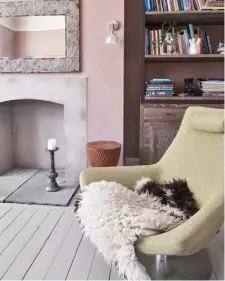  ??  ?? FIREPLACE In the lounge, the old fireplace has been replaced by a contempora­ry, concrete render surround. The couple intend to install a woodburner. For a similar bookshelf, try Graham &amp; Green