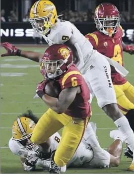  ?? Photograph­s by Luis Sinco Los Angeles Times ?? USC running back Austin Jones fights for extra yardage against Arizona State in the first quarter at the Coliseum. The Trojans amassed 487 yards of offense.