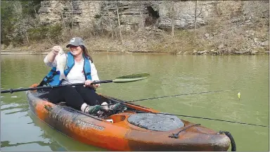  ?? File photo ?? Becky Roark of Fayettevil­le shows a white bass she caught in March 2020 on the War Eagle River. Walleye are usually the first fish to spawn, followed by white bass.