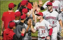  ?? ASSOCIATED PRESS ?? Brandon Drury (22), who homered and drove in four runs, and Mike Moustakas, who homered twice, celebrate with teammates following Friday’s 8-2 win in Pittsburgh. The surging Reds improved to 9-24 with their sixth win in eight games.