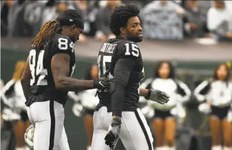  ?? Robert Reiners / Getty Images ?? The Raiders’ Cordarelle Patterson escorts Michael Crabtree off the field after Crabtree’s fight with Denver cornerback Aqib Talib at the Coliseum on Sunday.